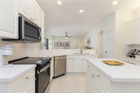a kitchen with a sink stove and microwave