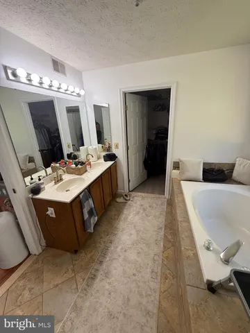 a bathroom with sink a mirror a vanity and a shower