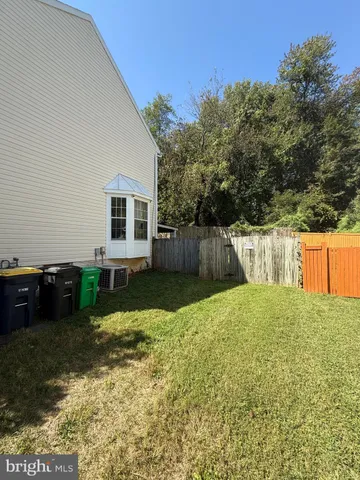 a view of a backyard with large trees