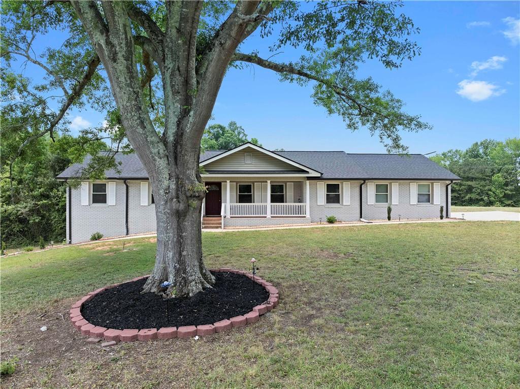 5245 Stonewall Tell Road Atlanta, GA 30349 - Photo 2 of 15 a front view of a house with a yard