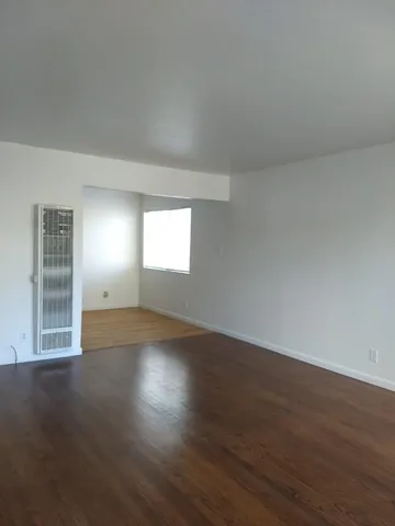 a view of wooden floor and windows in a room