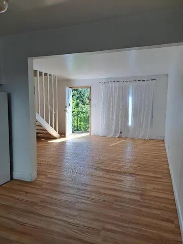 a view of room with window and wooden floor