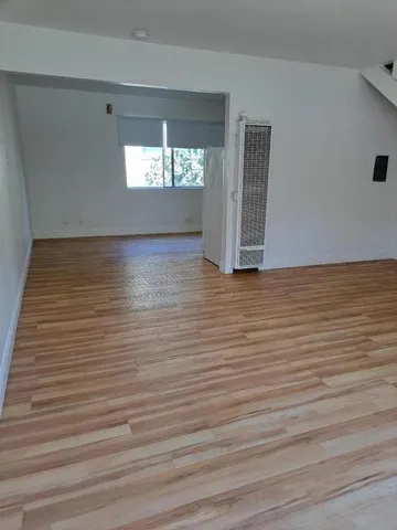 a view of wooden floor and windows in a room