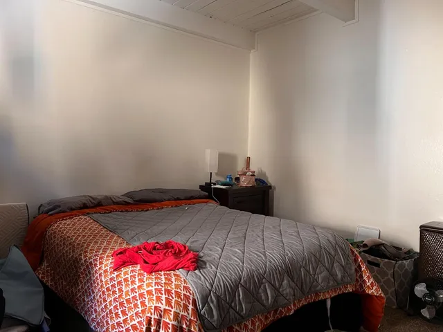 a bedroom with a bed and window