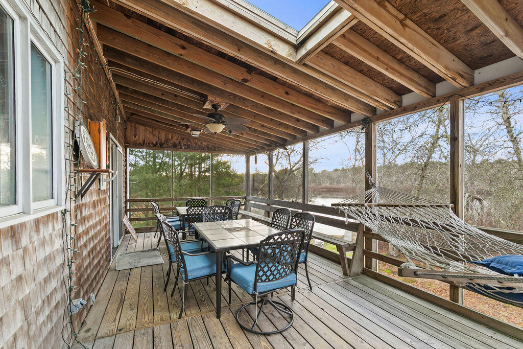 50 Circle Drive Hyannis, MA 02601 - Photo 25 of 32 a view of a roof deck with table and chairs and wooden floor