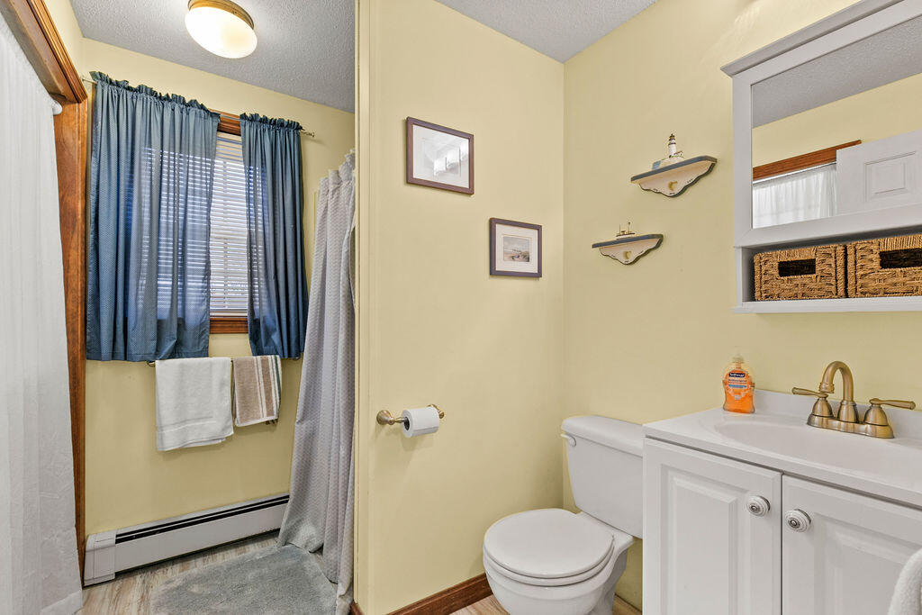 50 Circle Drive Hyannis, MA 02601 - Photo 28 of 32 a bathroom with a sink toilet and vanity