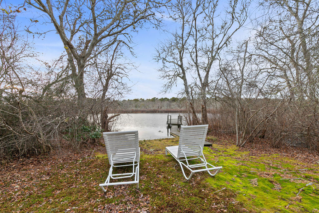 50 Circle Drive Hyannis, MA 02601 - Photo 6 of 32 a view of a chairs and table in the backyard