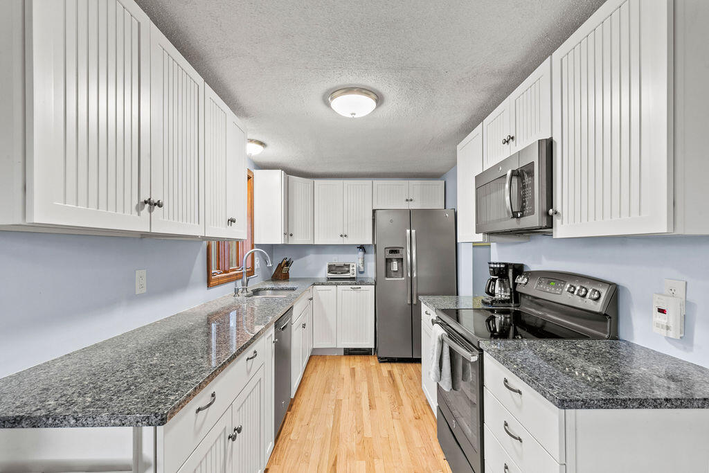 50 Circle Drive Hyannis, MA 02601 - Photo 8 of 32 a kitchen with refrigerator stove and microwave