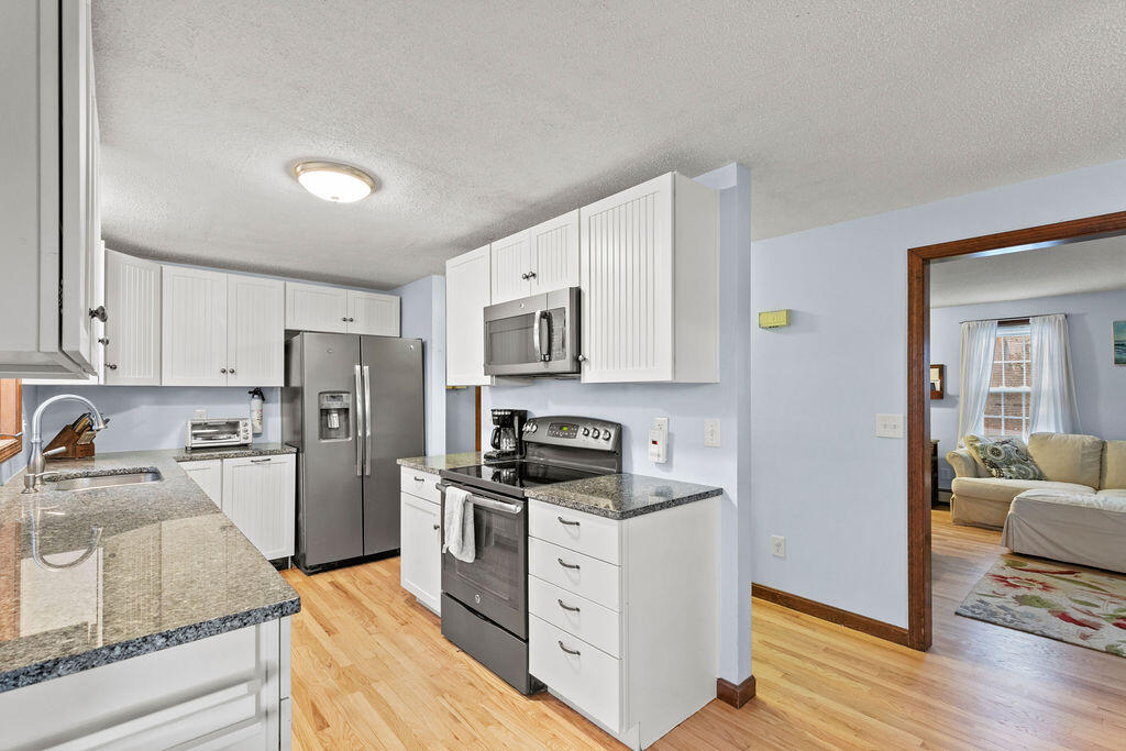 50 Circle Drive Hyannis, MA 02601 - Photo 10 of 32 a kitchen with stainless steel appliances granite countertop a refrigerator stove and sink