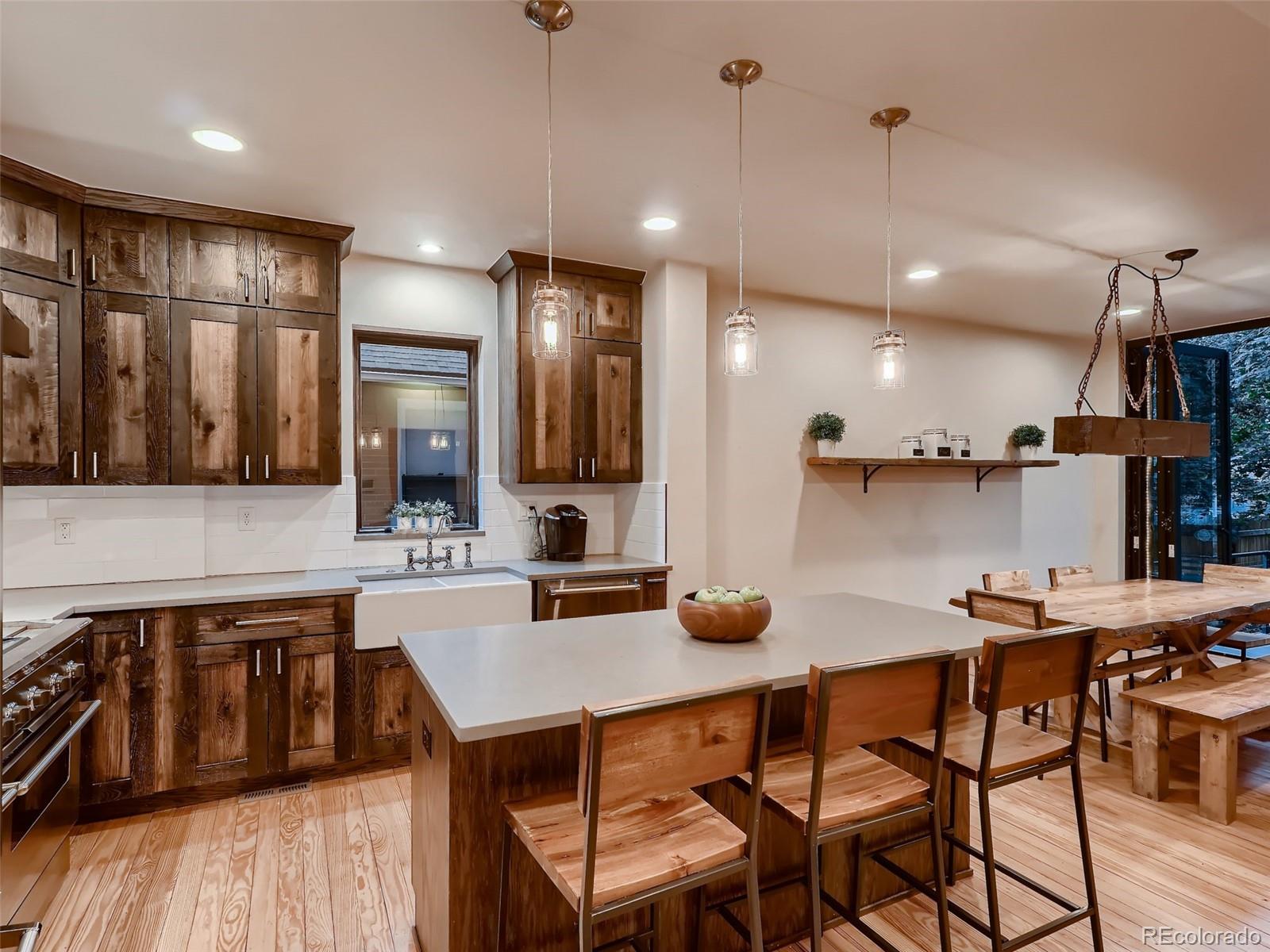 3548 Decatur Street Denver, CO 80211 - Photo 11 of 40 a kitchen with a table chairs stove and wooden floor