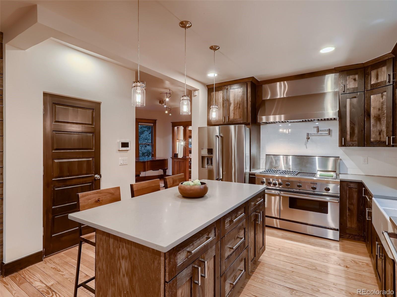 3548 Decatur Street Denver, CO 80211 - Photo 13 of 40 a kitchen with stainless steel appliances a sink stove and refrigerator