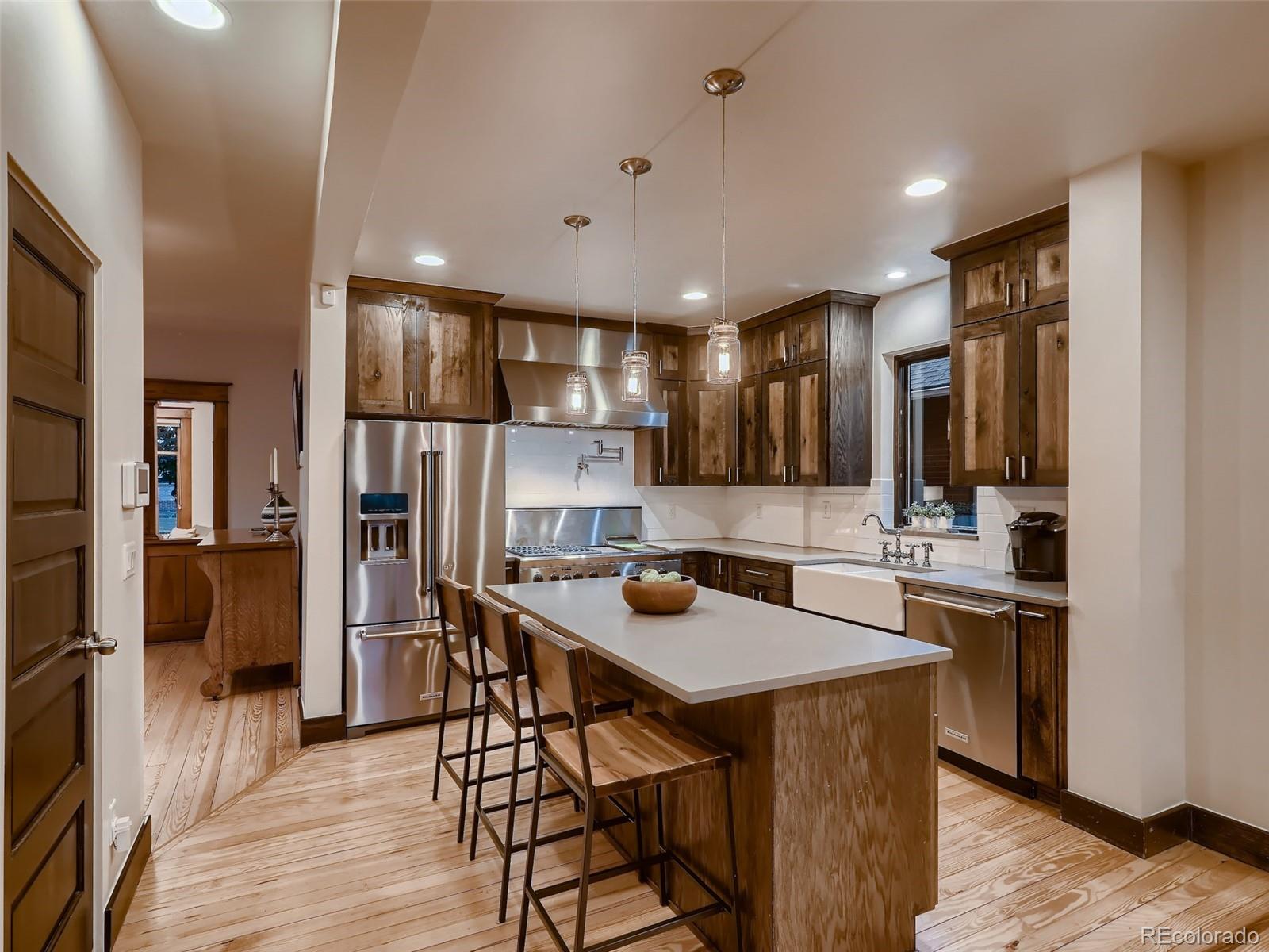 3548 Decatur Street Denver, CO 80211 - Photo 14 of 40 a kitchen with a table and chairs in it