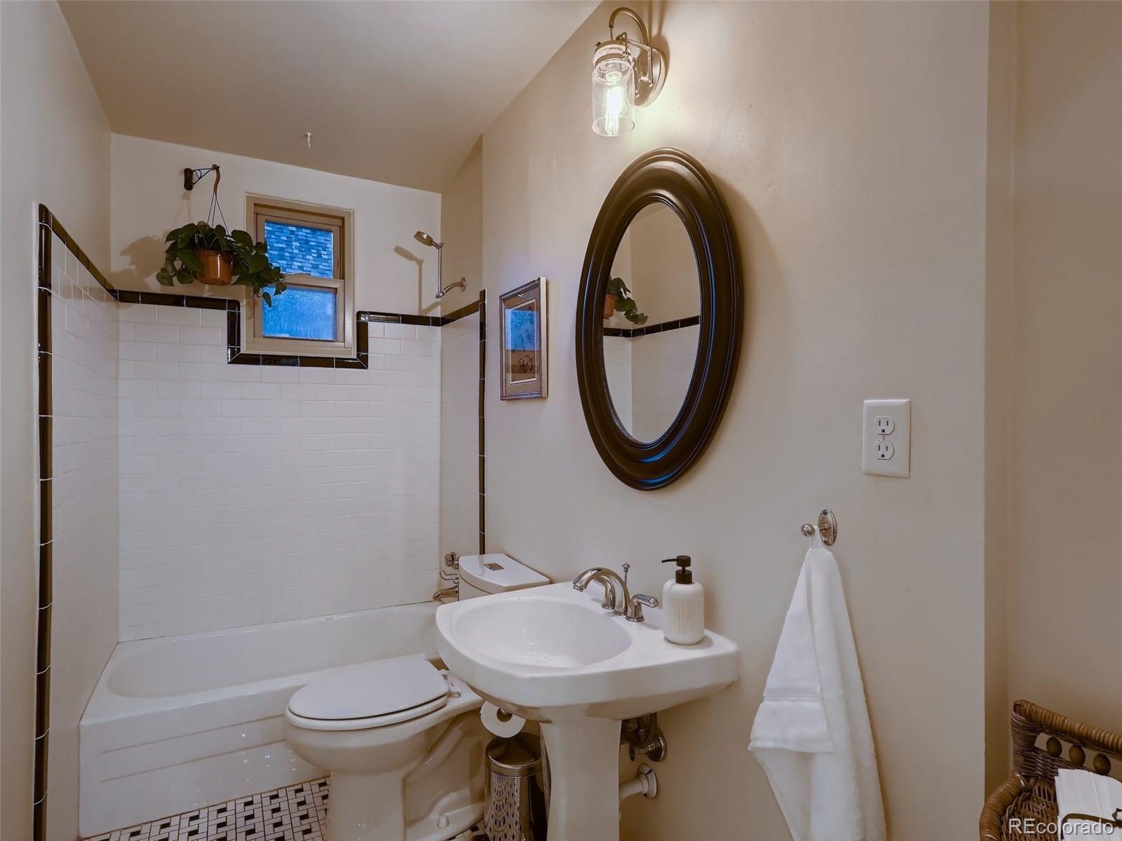 3548 Decatur Street Denver, CO 80211 - Photo 17 of 40 a bathroom with a sink a toilet and a mirror