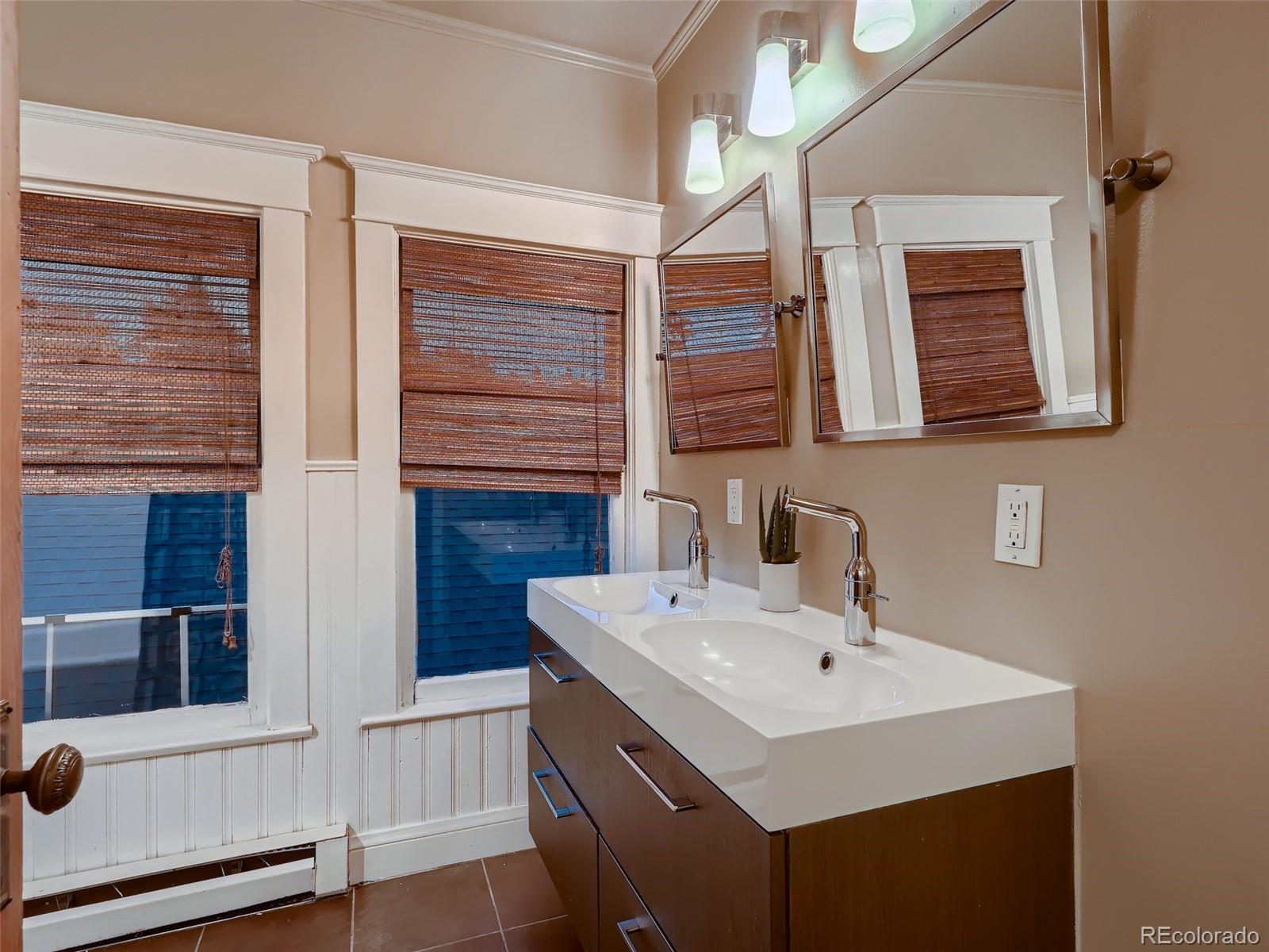 3548 Decatur Street Denver, CO 80211 - Photo 22 of 40 a bathroom with a sink and a mirror