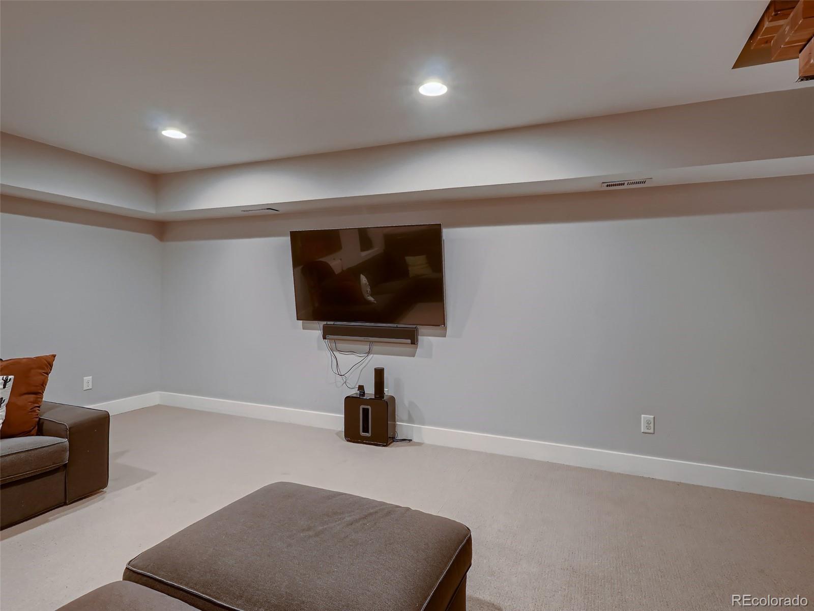 3548 Decatur Street Denver, CO 80211 - Photo 26 of 40 a living room with furniture and a flat screen tv