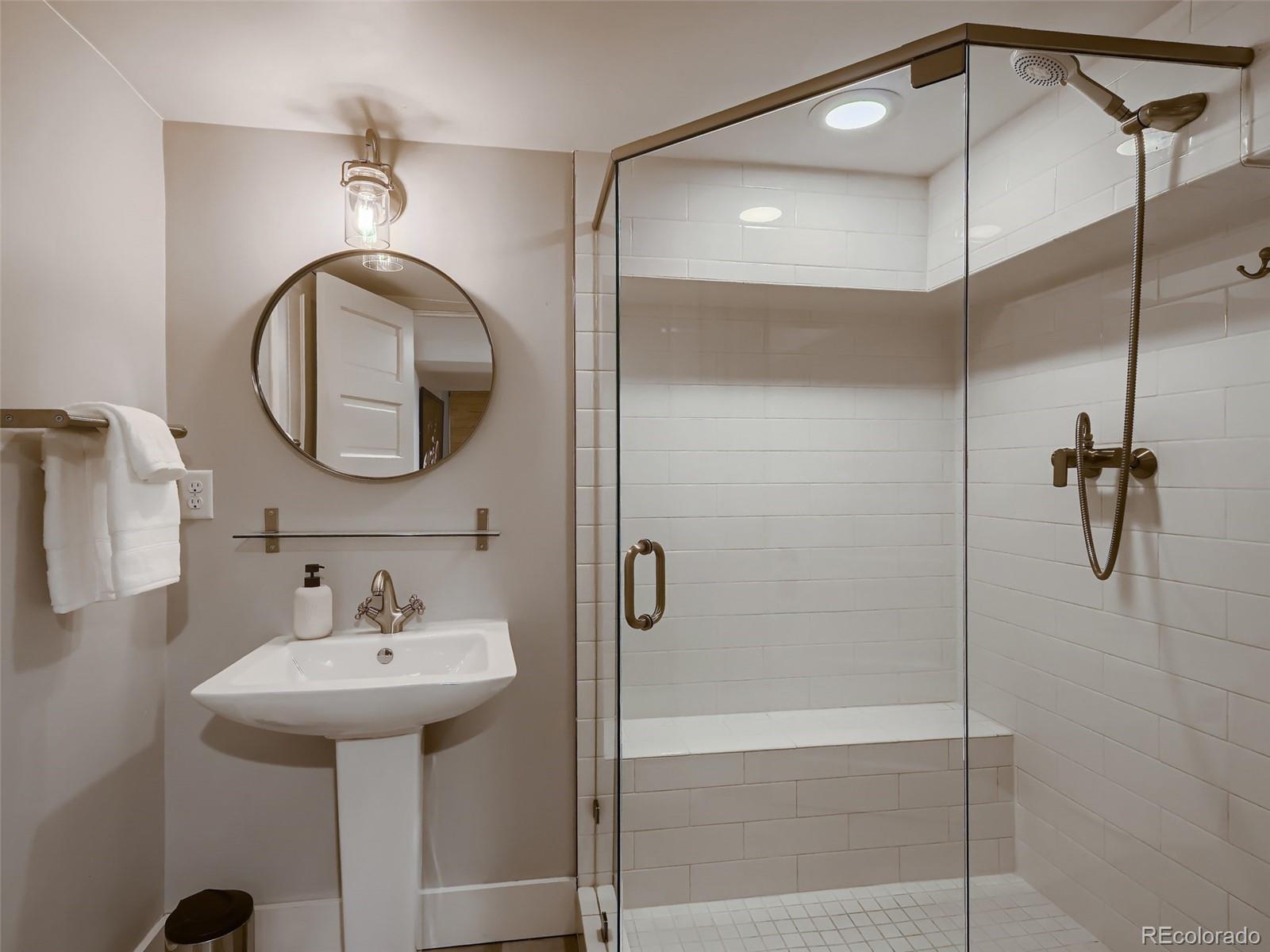 3548 Decatur Street Denver, CO 80211 - Photo 30 of 40 a bathroom with a sink shower and a mirror