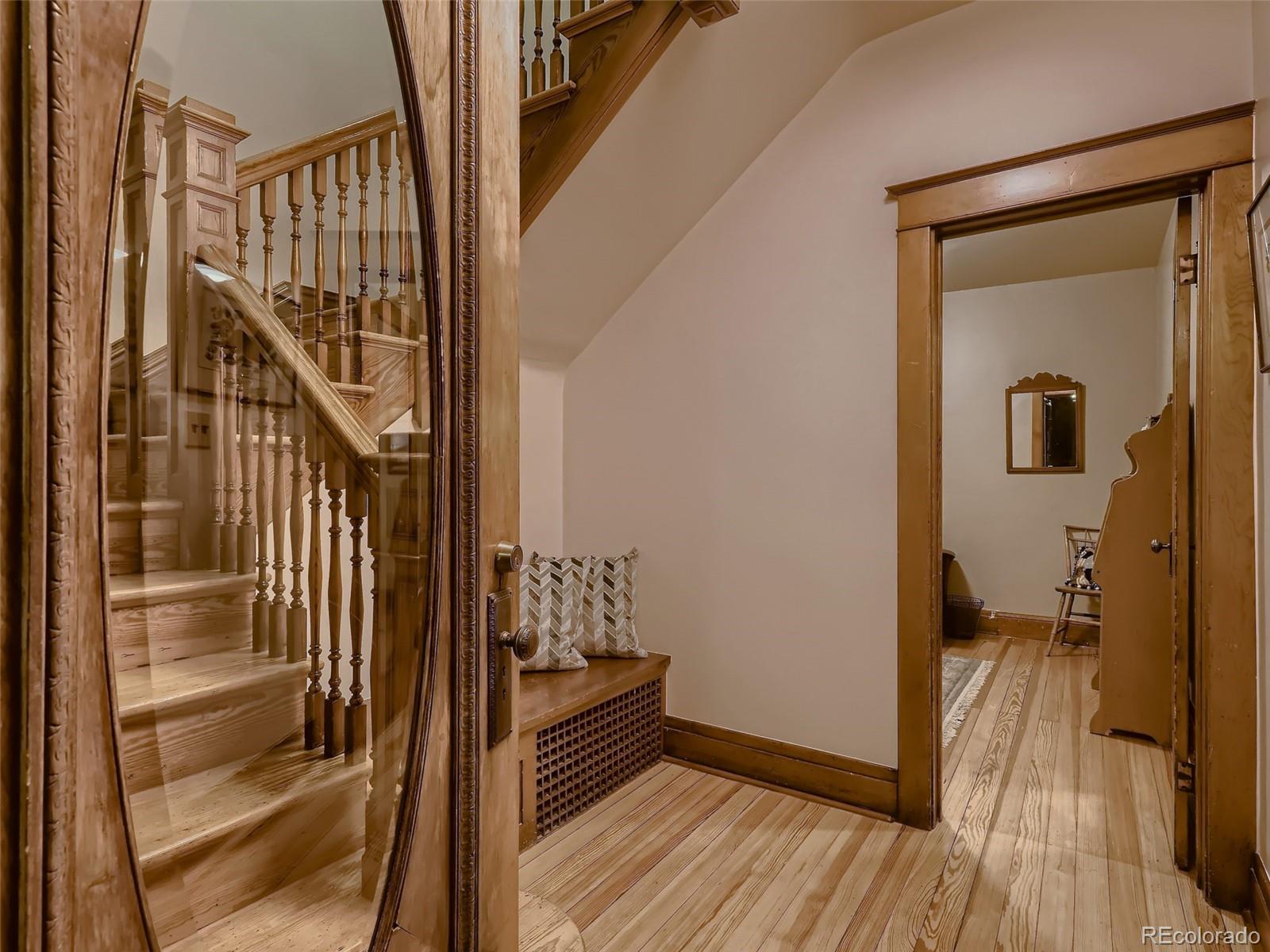 3548 Decatur Street Denver, CO 80211 - Photo 5 of 40 a view of a hallway with wooden floor and staircase