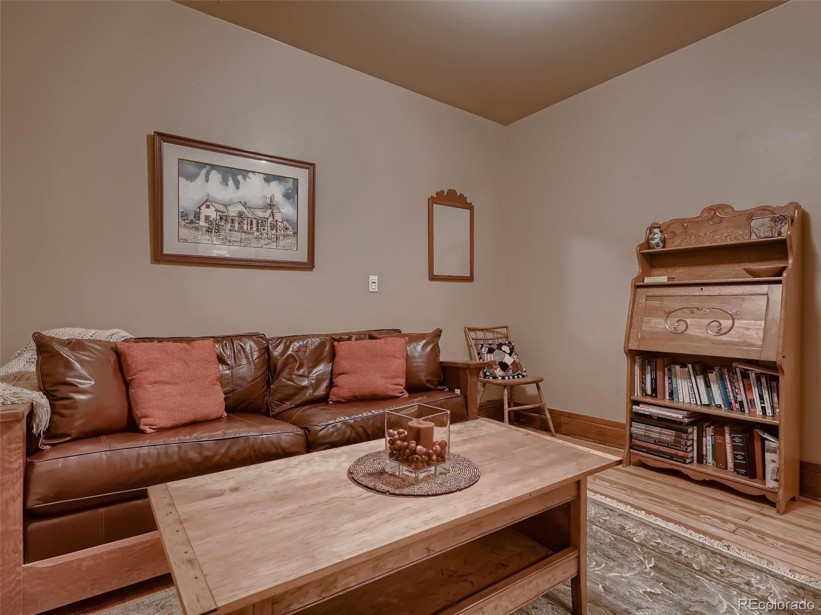 3548 Decatur Street Denver, CO 80211 - Photo 10 of 40 a living room with furniture and a shelf