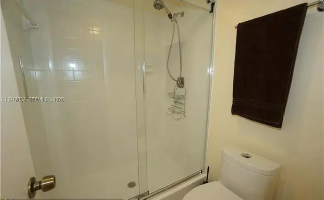 a bathroom with a shower and toilet