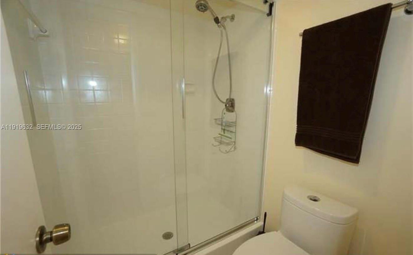 3521 Environ Boulevard, Unit B308 Lauderhill, FL 33319 - Photo 11 of 15 a bathroom with a shower and toilet