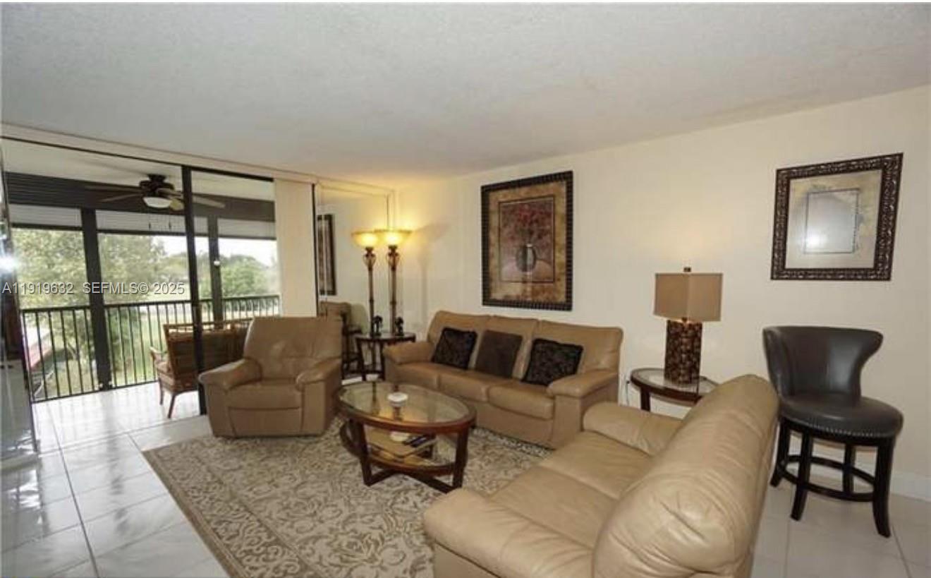 3521 Environ Boulevard, Unit B308 Lauderhill, FL 33319 - Photo 13 of 15 a living room with furniture and a window