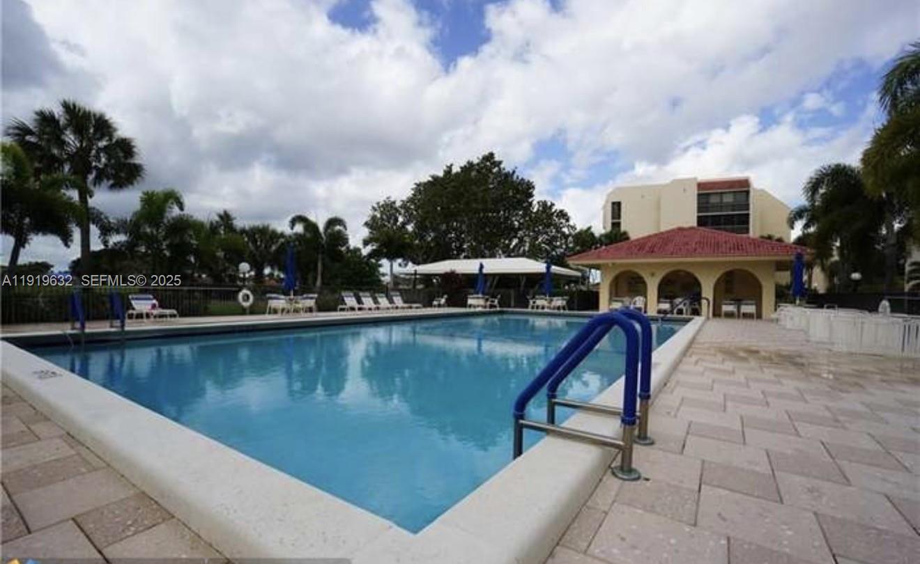 3521 Environ Boulevard, Unit B308 Lauderhill, FL 33319 - Photo 15 of 15 a view of swimming pool with outdoor seating and trees in the background