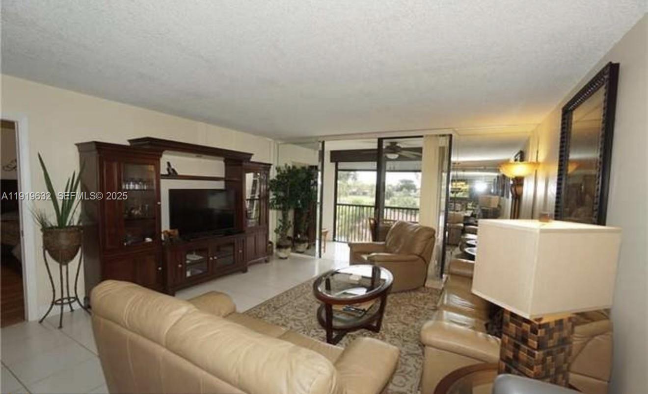 3521 Environ Boulevard, Unit B308 Lauderhill, FL 33319 - Photo 6 of 15 a living room with furniture and a flat screen tv