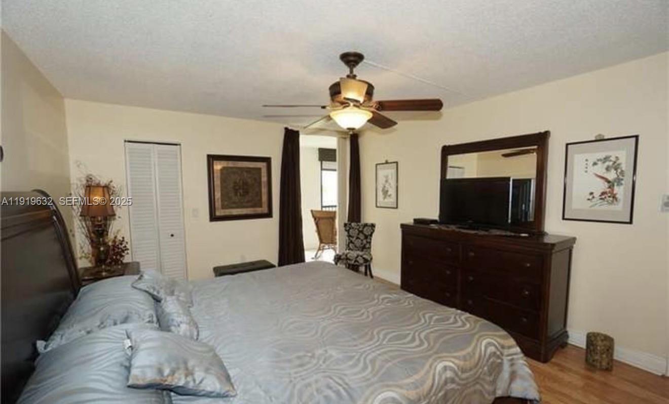 3521 Environ Boulevard, Unit B308 Lauderhill, FL 33319 - Photo 7 of 15 a bedroom with a bed and a flat screen tv