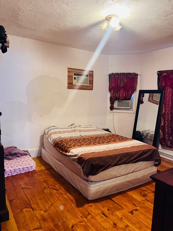 53 Hillside Avenue Everett, MA 02149 - Photo 11 of 11 a bedroom with a bed and furniture