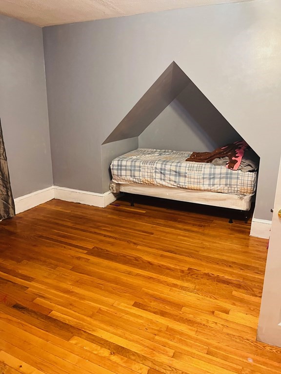53 Hillside Avenue Everett, MA 02149 - Photo 5 of 11 a view of a room with wooden floor and white walls