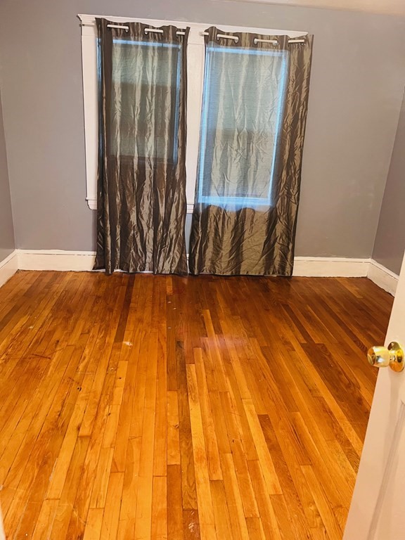 53 Hillside Avenue Everett, MA 02149 - Photo 6 of 11 a view of a room with wooden floor and a window