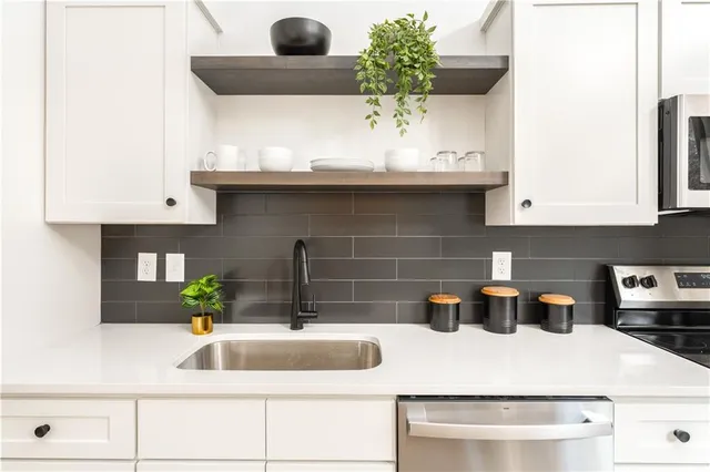 a kitchen with a sink and cabinets