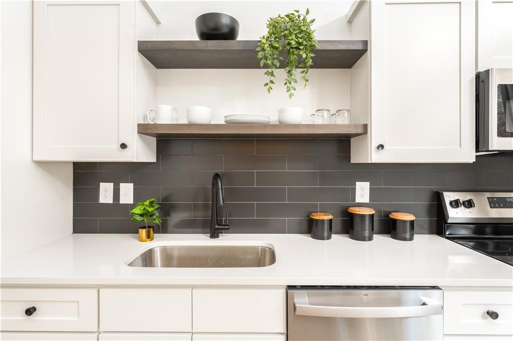 1160 Gracewood Avenue Southeast, Unit 111 Atlanta, GA 30316 - Photo 12 of 38 a kitchen with a sink and cabinets