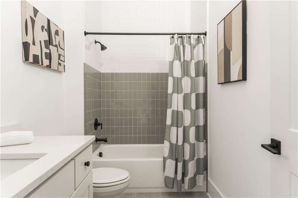 1160 Gracewood Avenue Southeast, Unit 111 Atlanta, GA 30316 - Photo 14 of 38 a bathroom with a shower a toilet and a sink