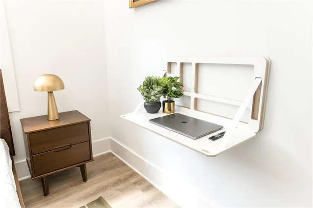 a living room with furniture and a potted plant