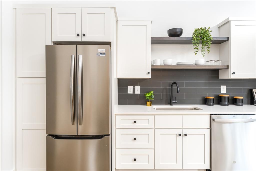 1160 Gracewood Avenue Southeast, Unit 111 Atlanta, GA 30316 - Photo 21 of 38 a kitchen with stainless steel appliances a refrigerator and cabinets