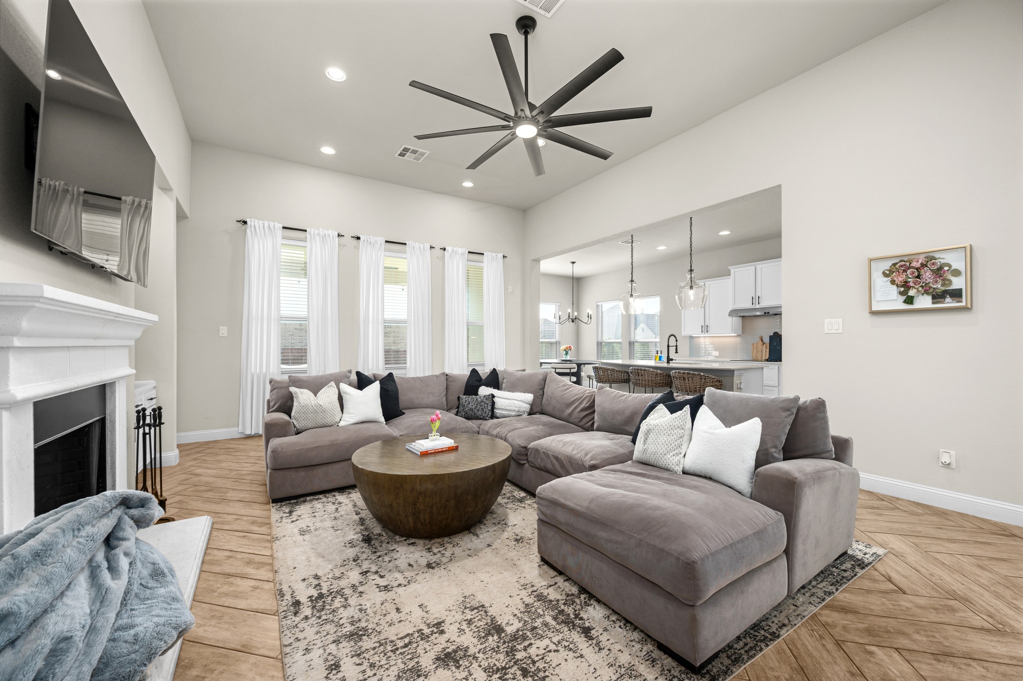 2100 Highland Ridge Road Georgetown, TX 78628 - Photo 10 of 30 A welcoming open-concept living area with soaring ceilings and a grand fireplace invites relaxation.