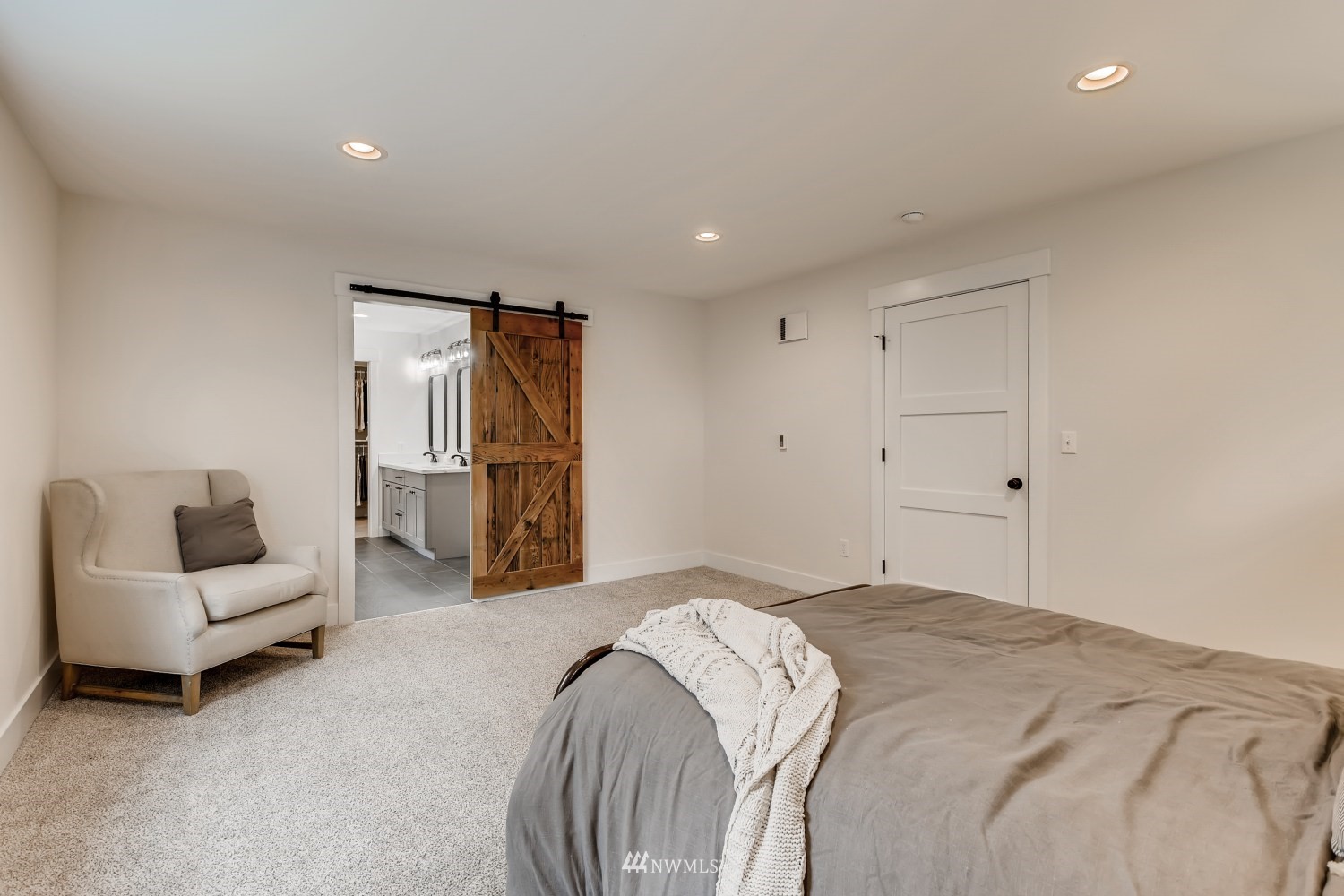 28313 Florence Acres Road Monroe, WA 98272 - Photo 12 of 27 a spacious bedroom with a bed and a couch