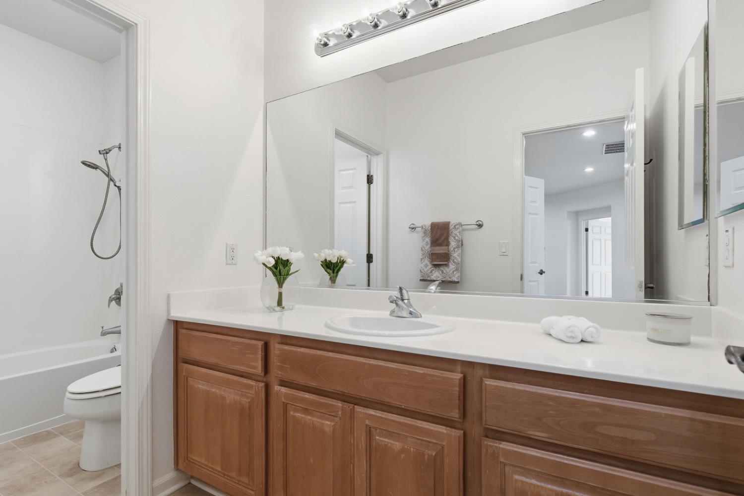 1012 Rock Harbor Point Hercules, CA 94547 - Photo 28 of 53 a bathroom with a granite countertop sink a toilet and a mirror