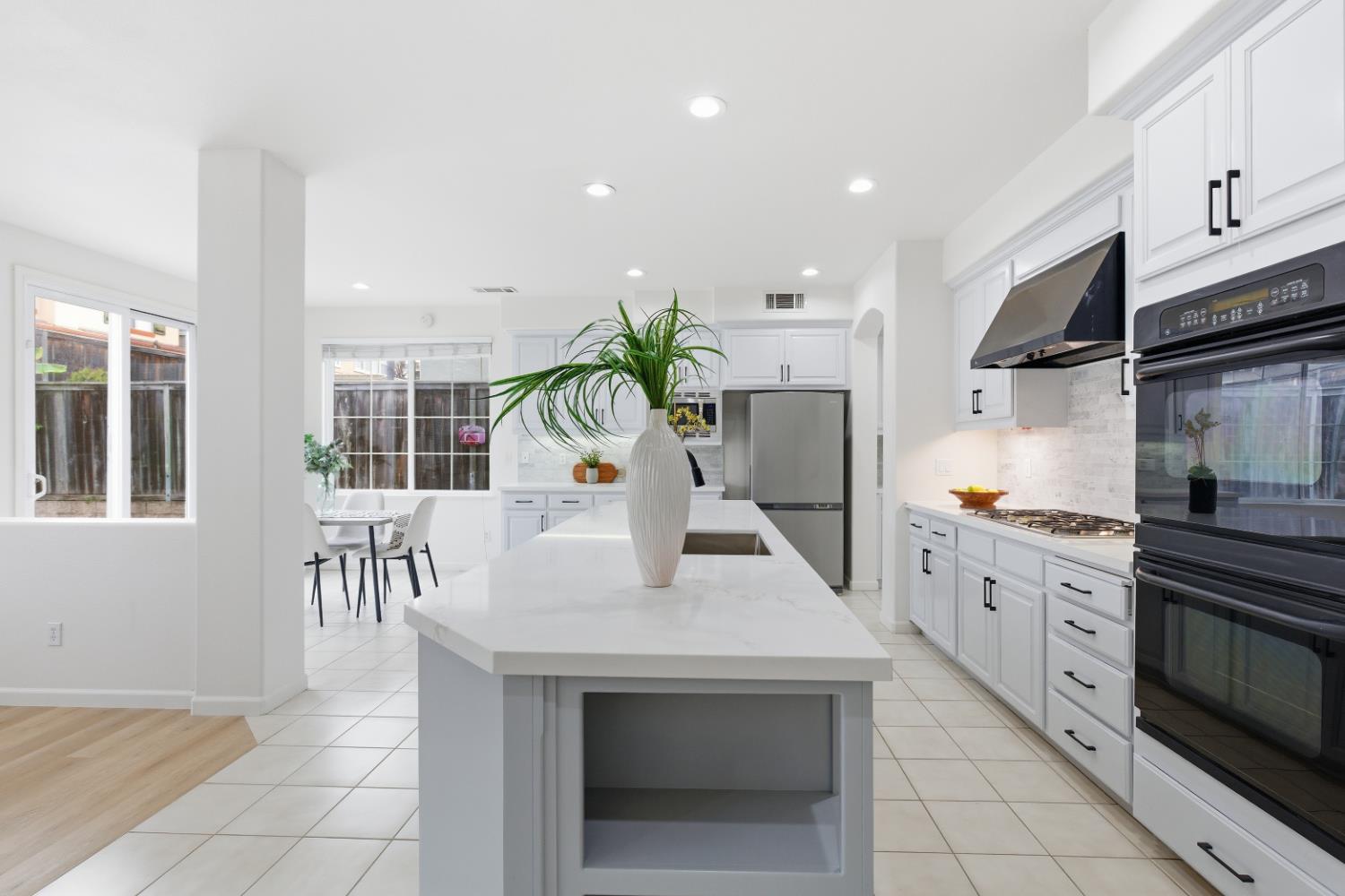 1012 Rock Harbor Point Hercules, CA 94547 - Photo 9 of 53 a kitchen with stainless steel appliances kitchen island granite countertop a stove a sink and a refrigerator
