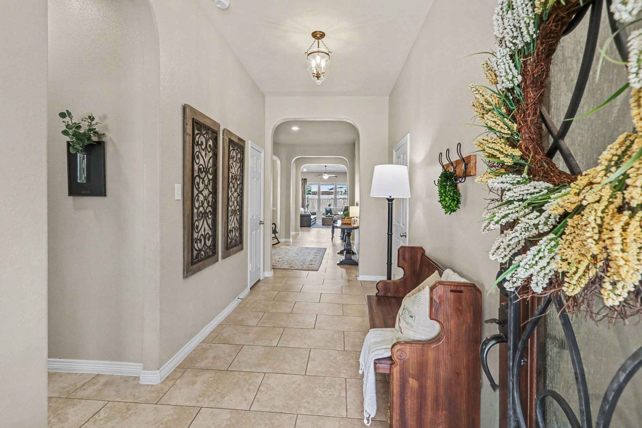 27006 Cliff Pointe Lane Katy, TX 77494 - Photo 4 of 34 Step inside to a long, elegant entry with arched doorways, warm tile floors, and sightlines that draw you straight into the heart of the home.