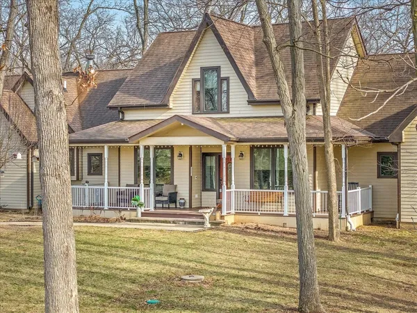 a living room with furniture kitchen view and a large window