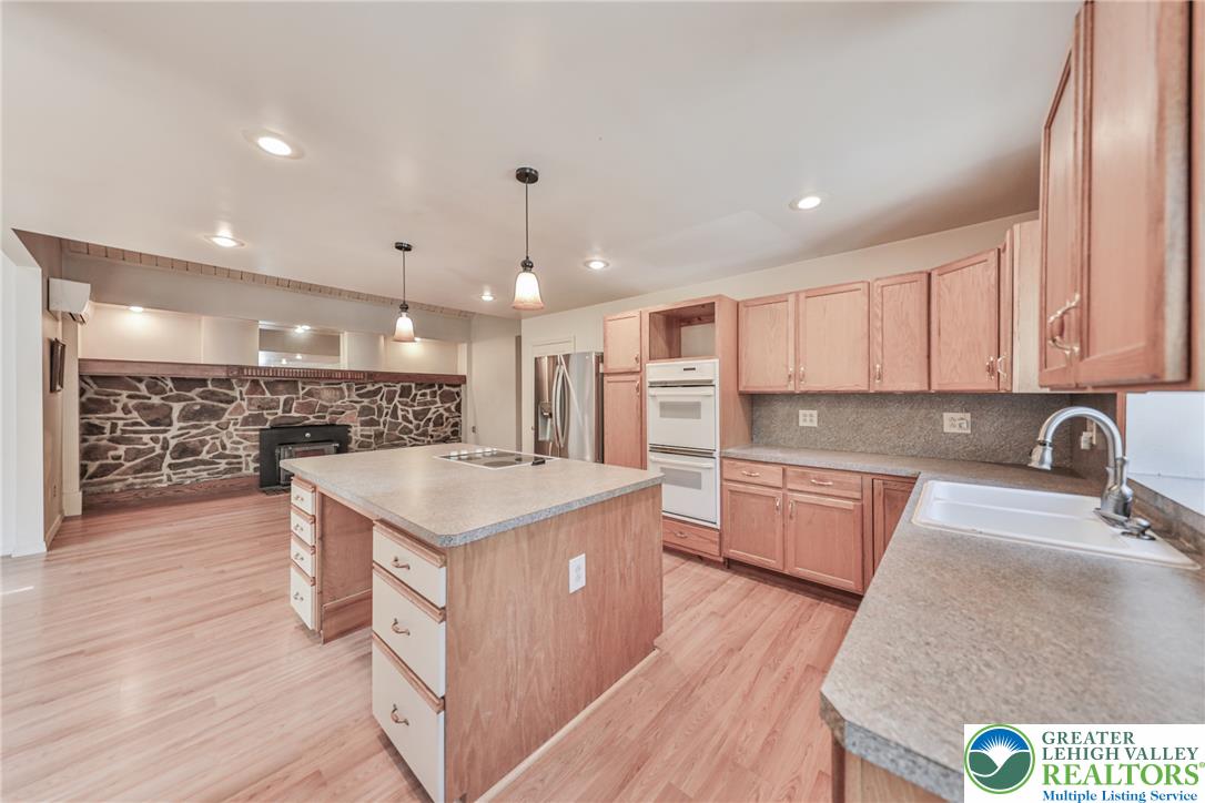 152 Inverhouse Road Henryville, PA 18332 - Photo 26 of 64 A well-equipped kitchen space features a practical island with an integrated cooktop and ample cabinetry.