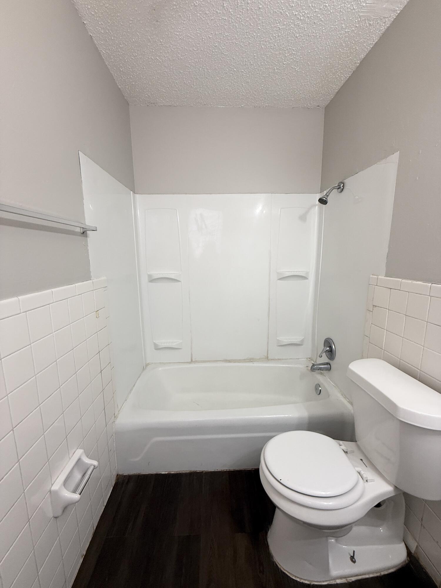 922 44th Street, Unit A Lubbock, TX 79412 - Photo 13 of 16 a bathroom with a toilet and a bath tub