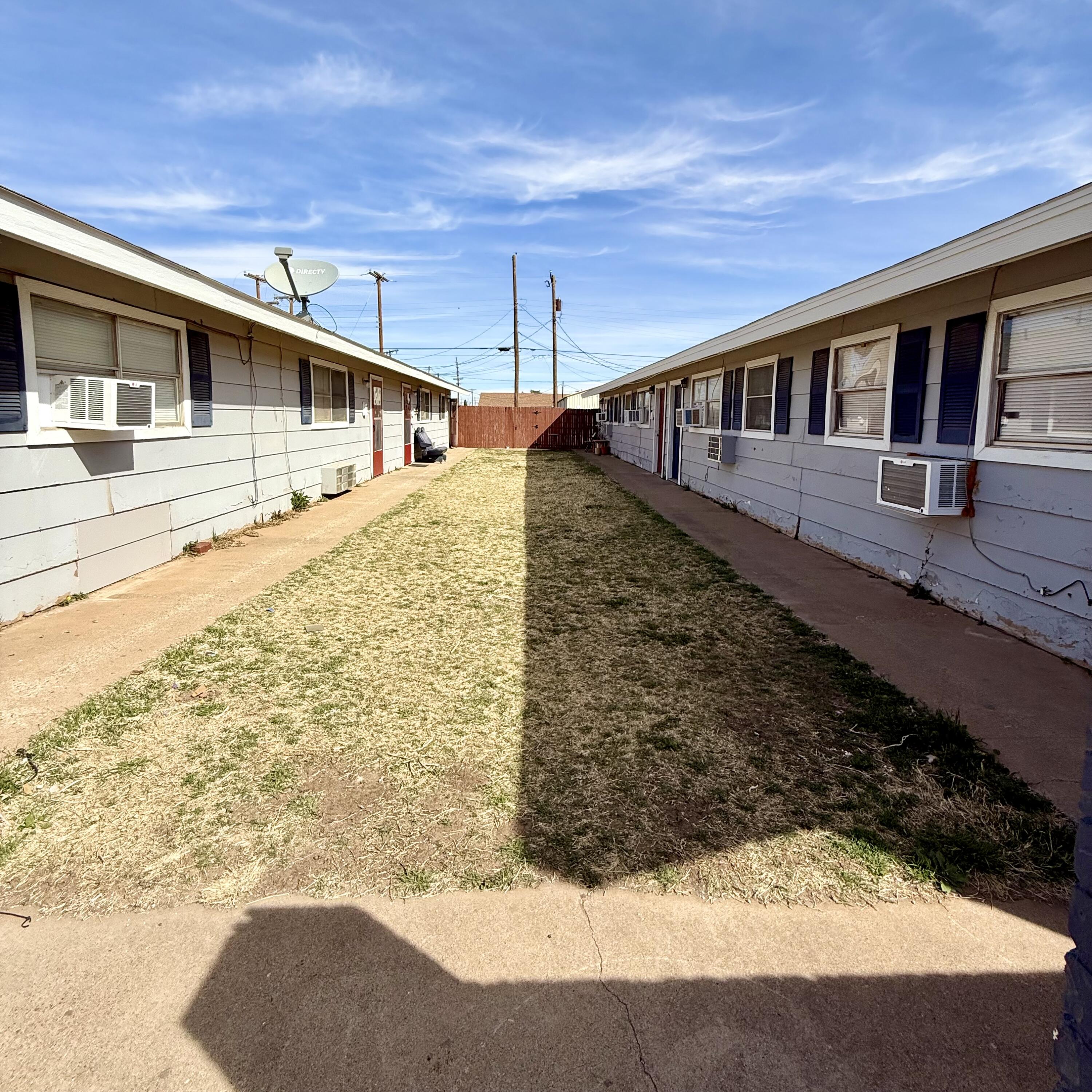 922 44th Street, Unit A Lubbock, TX 79412 - Photo 2 of 16 a front view of a house with a yard