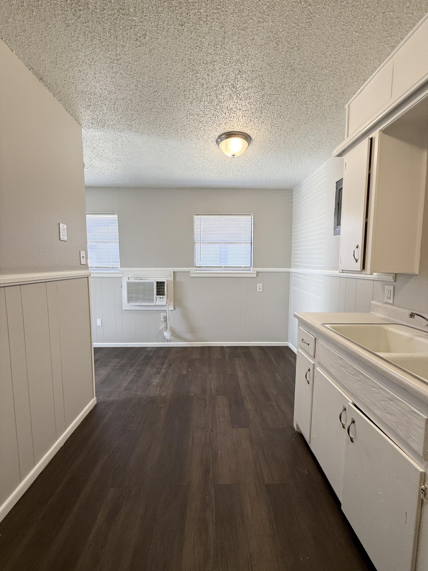 922 44th Street, Unit A Lubbock, TX 79412 - Photo 9 of 16 a view of a sink and dishwasher with wooden floor