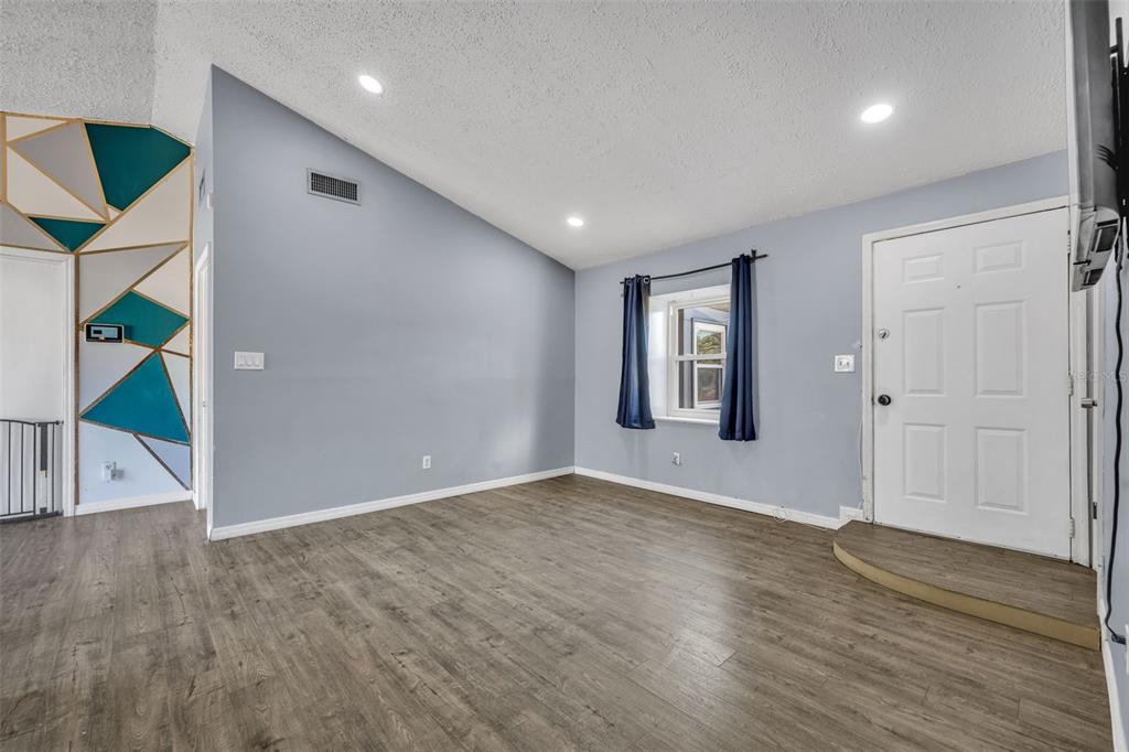 222 West Panama Road Winter Springs, FL 32708 - Photo 7 of 25 an empty room with wooden floor and windows