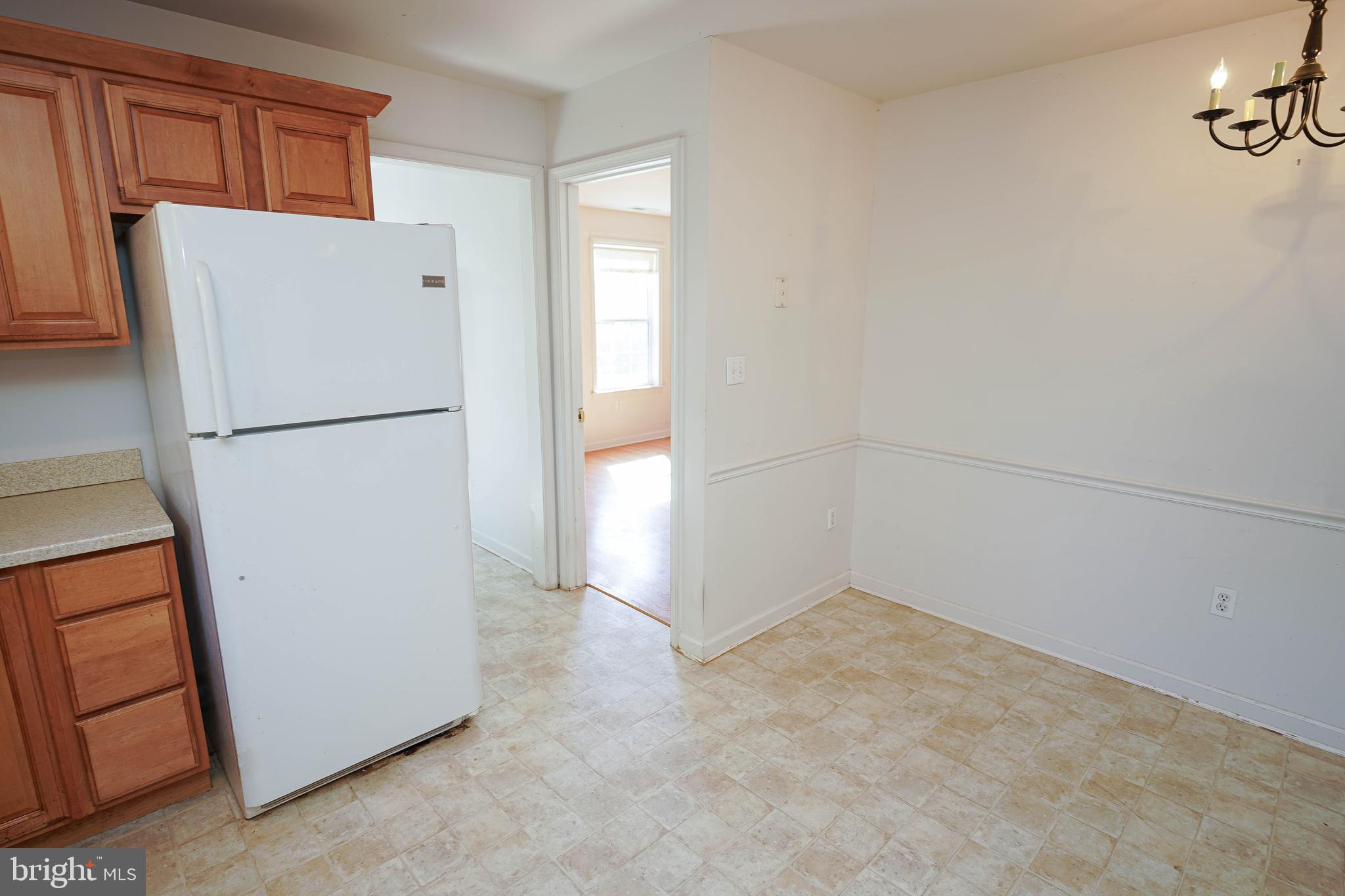 23290 Custom House Road Deal Island, MD 21821 - Photo 11 of 64 a white refrigerator freezer and a refrigerator in a kitchen