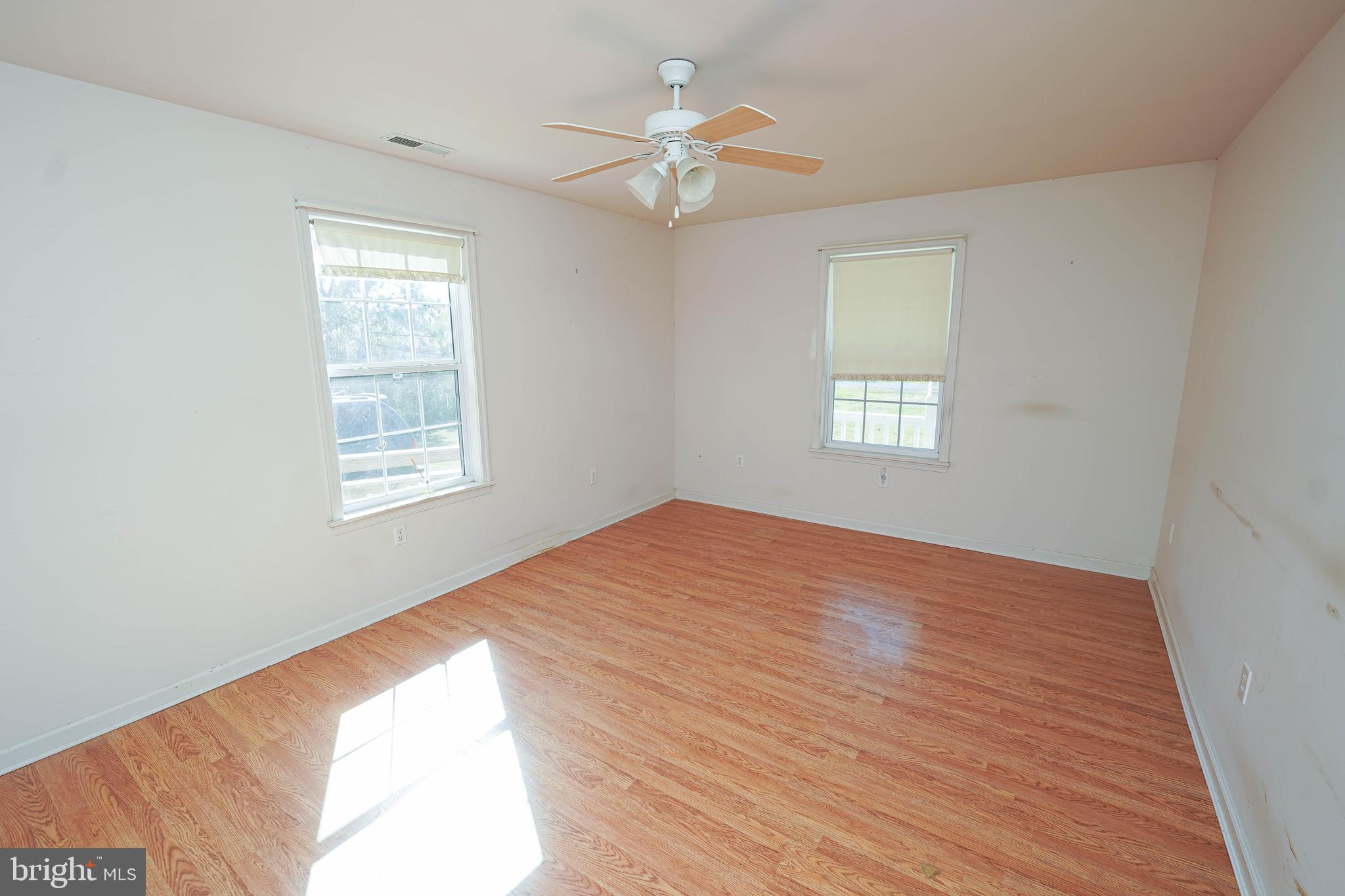23290 Custom House Road Deal Island, MD 21821 - Photo 17 of 64 a view of empty room with wooden floor and fan