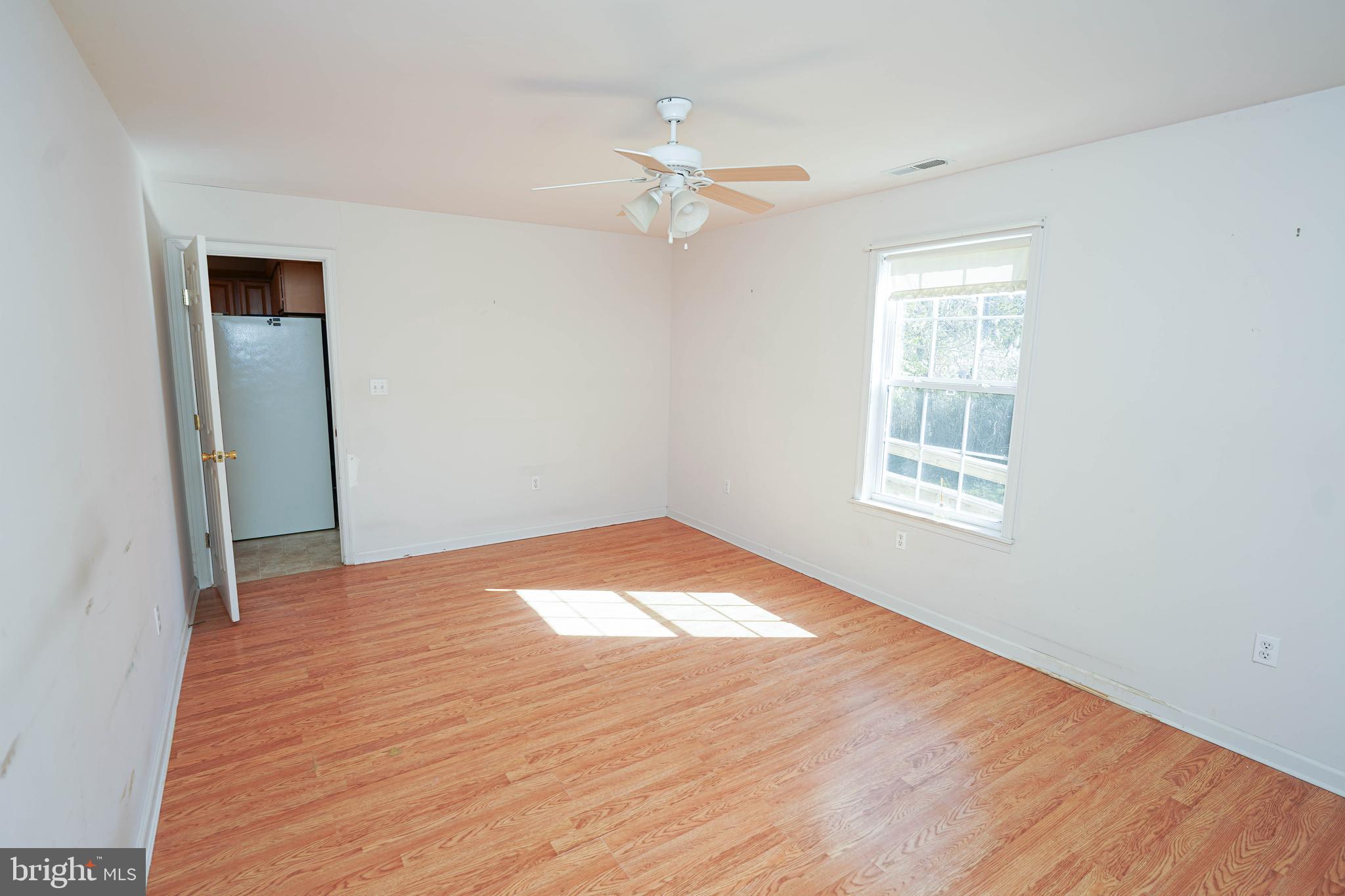 23290 Custom House Road Deal Island, MD 21821 - Photo 20 of 64 a view of empty room with wooden floor and fan